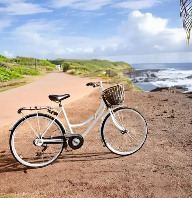 A bike on a scenic route surrounded by lush greenery and mountains in Kauai