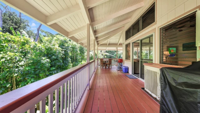 Relax on the outdoor deck of The Guest House at River Estate, featuring a dining area, BBQ, and stunning river view. Outdoor Dining with Stunning River Views