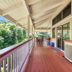 River Estate — Kauaʻi North Shore Vacation Rental | Gallery Outdoor deck of The Guest House at River Estate with dining area, BBQ, and river view
