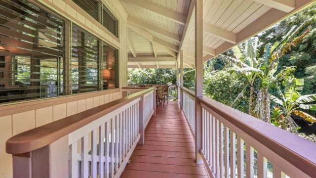 Relax on the front deck of The Guest House at River Estate, Kauai. Enjoy the serene surroundings, luxurious amenities, and beautiful views. Unwind on the Serene Front Deck with Stunning Views