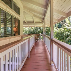Relax on the front deck of The Guest House at River Estate, Kauai. Enjoy the serene surroundings, luxurious amenities, and beautiful views. Front deck of The Guest House at River Estate with a beautiful view and luxury amenities