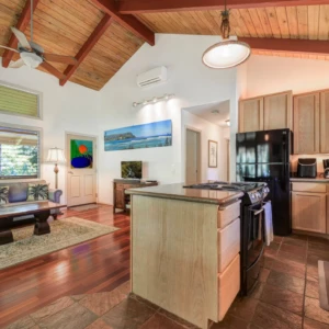 Enjoy the cozy furnishings and modern appliances in the kitchen and living room of The Guest House at River Estate, Kauai. Kitchen and living room of The Guest House at River Estate with modern appliances and cozy furnishings