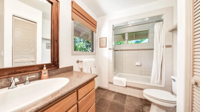 Indulge in the luxury of The Guest House master bathroom at River Estate, featuring an elegant sink and modern fixtures. Modern Elegance in the Master Bathroom
