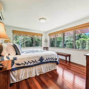 River Estate — Kauaʻi North Shore Vacation Rental | Gallery Master bedroom of The Guest House at River Estate with river view and elegant decor