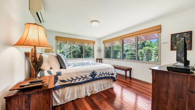 Experience luxury and tranquility in the master bedroom of The Guest House at River Estate, featuring stunning river views and elegant decor. Wake Up to Stunning River Views in Elegant Luxury