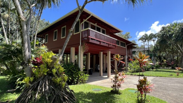 Discover the beauty of The River House at River Estate, Kauai, surrounded by lush greenery and natural beauty. Stunning Exterior of The River House Surrounded by Lush Greenery