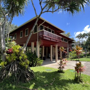Discover the beauty of The River House at River Estate, Kauai, surrounded by lush greenery and natural beauty. Exterior view of The River House at River Estate, Kauai with lush greenery