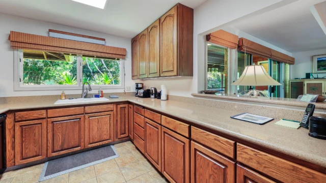 Enjoy the convenience of the kitchen with a pass-through window at The River House, River Estate, perfect for serving meals and entertaining. Convenient Kitchen with Pass-Through Window