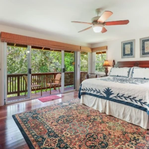River Estate — Kauaʻi North Shore Vacation Rental | Gallery Master bedroom at The River House, River Estate with river view and elegant furnishings