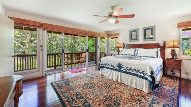 Relax in the elegant master bedroom of The River House at River Estate, featuring stunning river views and luxurious furnishings. Elegant Master Bedroom with Stunning River Views
