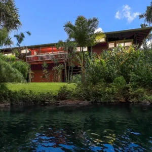 Enjoy a luxurious stay at The River House, a premier Kauai vacation rental with riverfront views, elegant Tommy Bahama furnishings, and modern amenities. Perfect for families and groups seeking a tranquil escape. Luxurious Kauai vacation rental at The River House with riverfront views, Tommy Bahama furnishings, and modern amenities