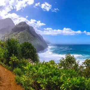 Discover the natural beauty of Kauai on a hiking trail with stunning ocean and mountain views. https://riverestate.com/